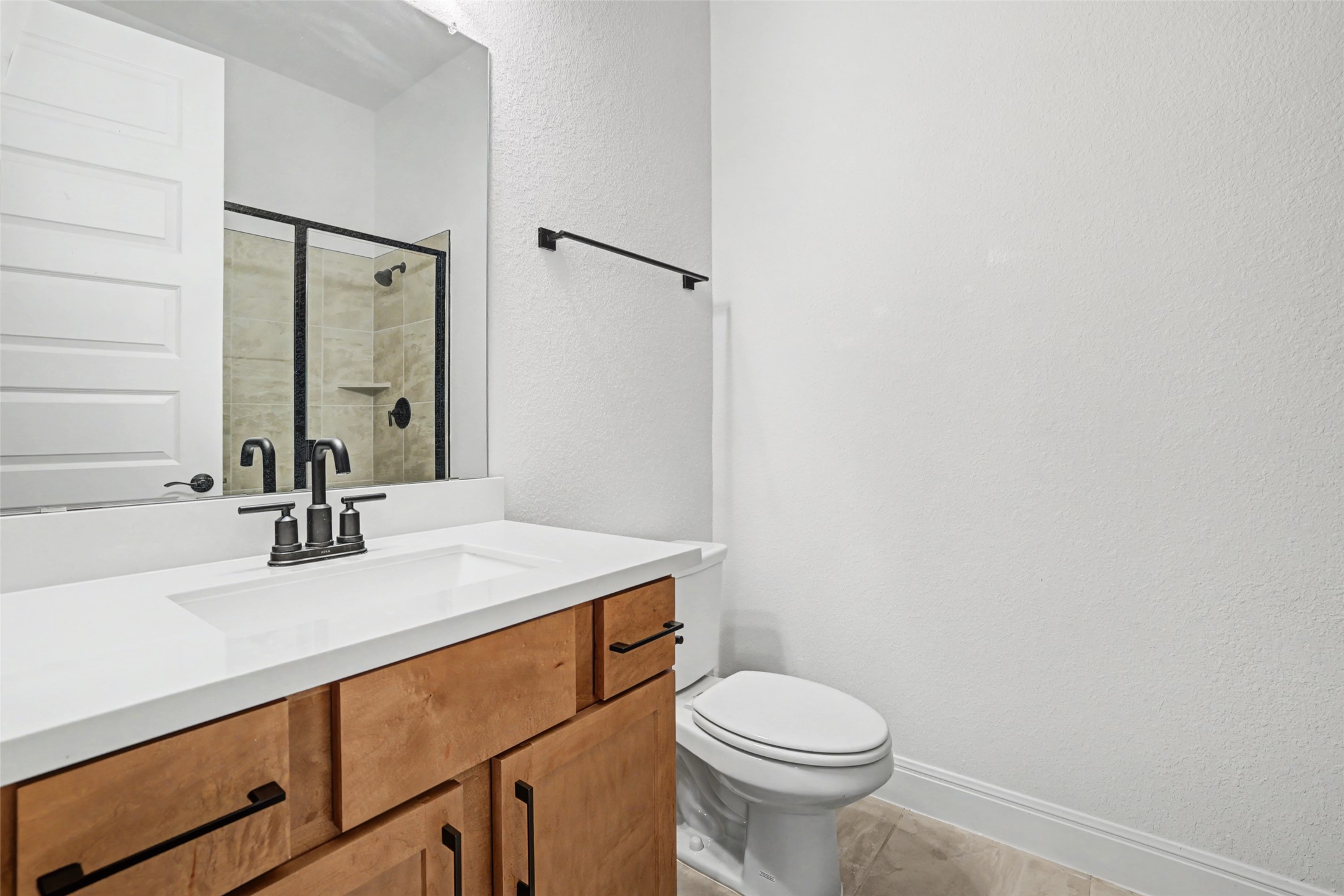 104 Rocky River Road Georgetown, TX 78628 - Photo 30 of 39 a bathroom with a sink a toilet and a mirror