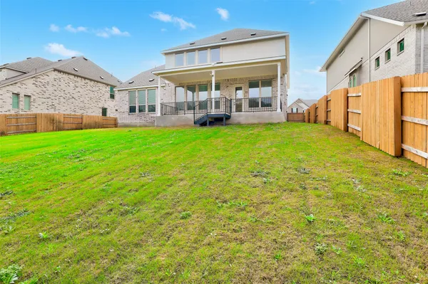 a view of a house with a backyard porch and sitting area