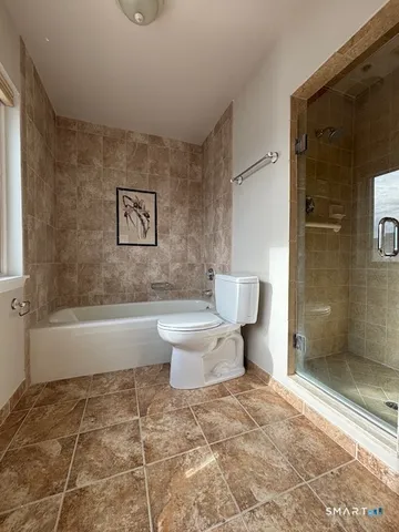 a bathroom with a toilet a sink and shower