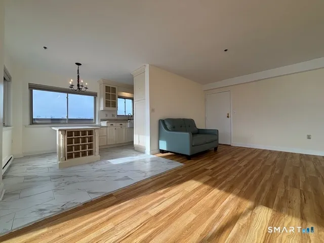 a view of a livingroom with wooden floor and a ceiling fan