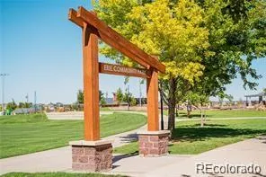 a front view of a house with a tree