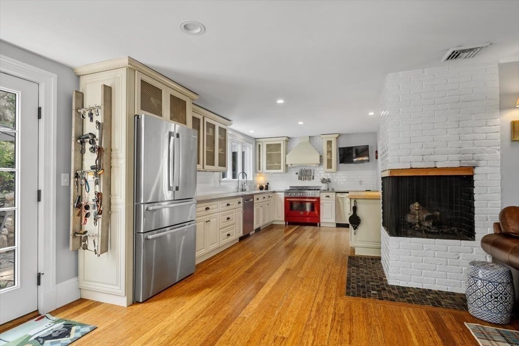 241 Jerusalem Road Cohasset, MA 02025 - Photo 11 of 42 a kitchen with stainless steel appliances a refrigerator a stove top oven and white walls