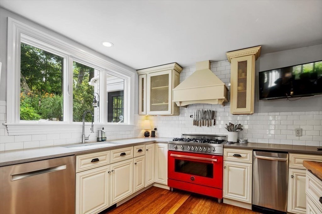 241 Jerusalem Road Cohasset, MA 02025 - Photo 13 of 42 a kitchen with stainless steel appliances granite countertop a stove a sink and a microwave