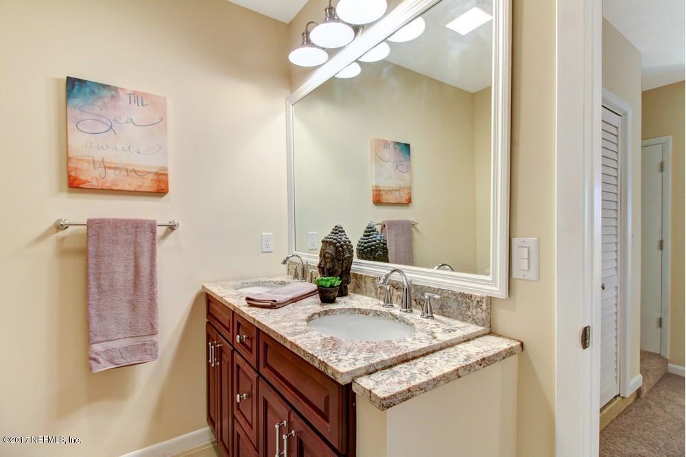 10633 Villanova Road Jacksonville, FL 32218 - Photo 16 of 28 a bathroom with a granite countertop sink a mirror and a shower