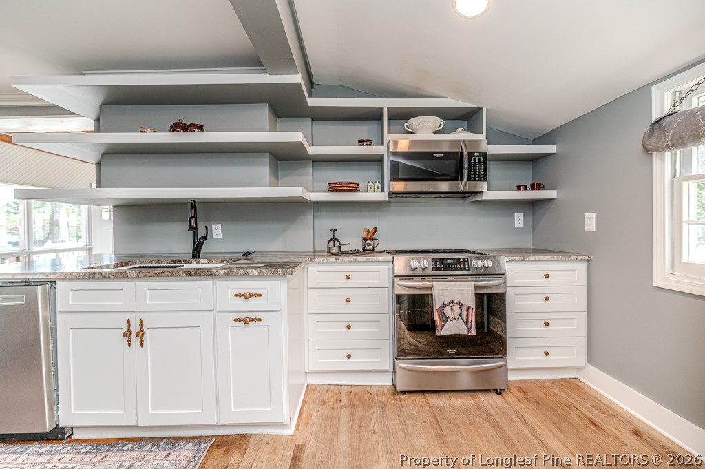 509 Carthage Street Cameron, NC 28326 - Photo 25 of 43 a kitchen with stainless steel appliances cabinets and a window