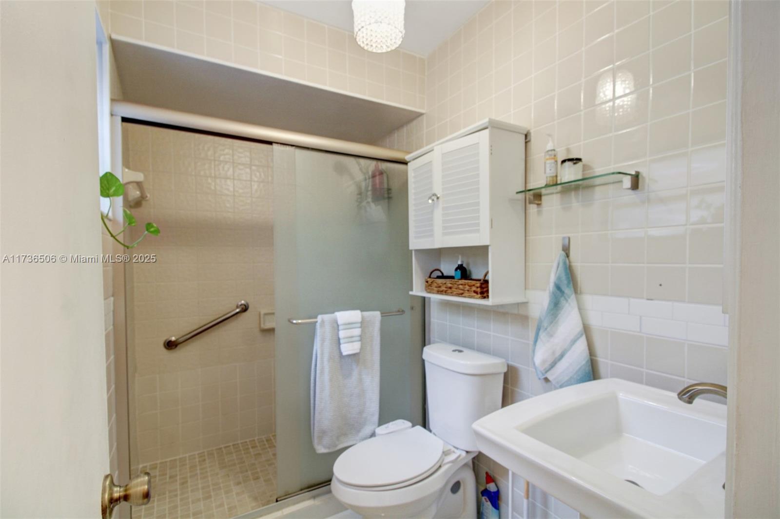 6425 Southwest 133rd Place Miami, FL 33183 - Photo 13 of 25 a white toilet sitting next to a bathroom sink