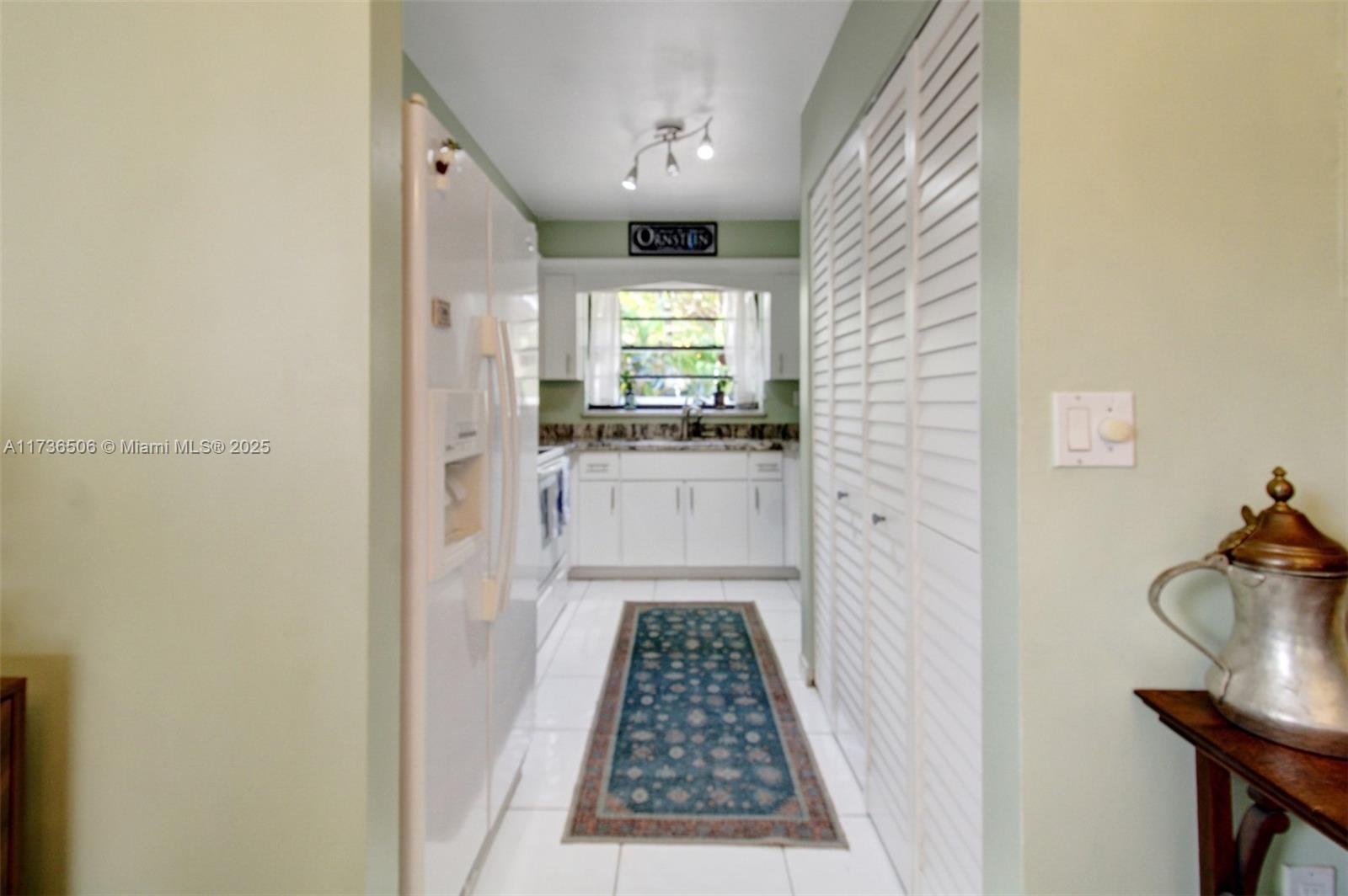 6425 Southwest 133rd Place Miami, FL 33183 - Photo 15 of 25 a hallway with a dining table and a window