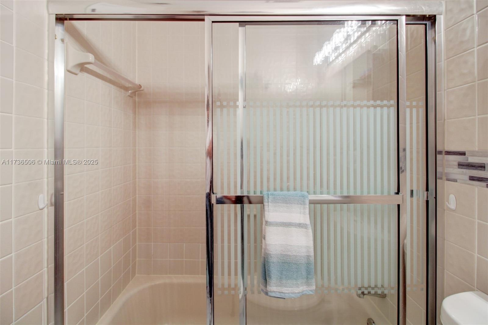 6425 Southwest 133rd Place Miami, FL 33183 - Photo 20 of 25 a bathroom with a glass shower door
