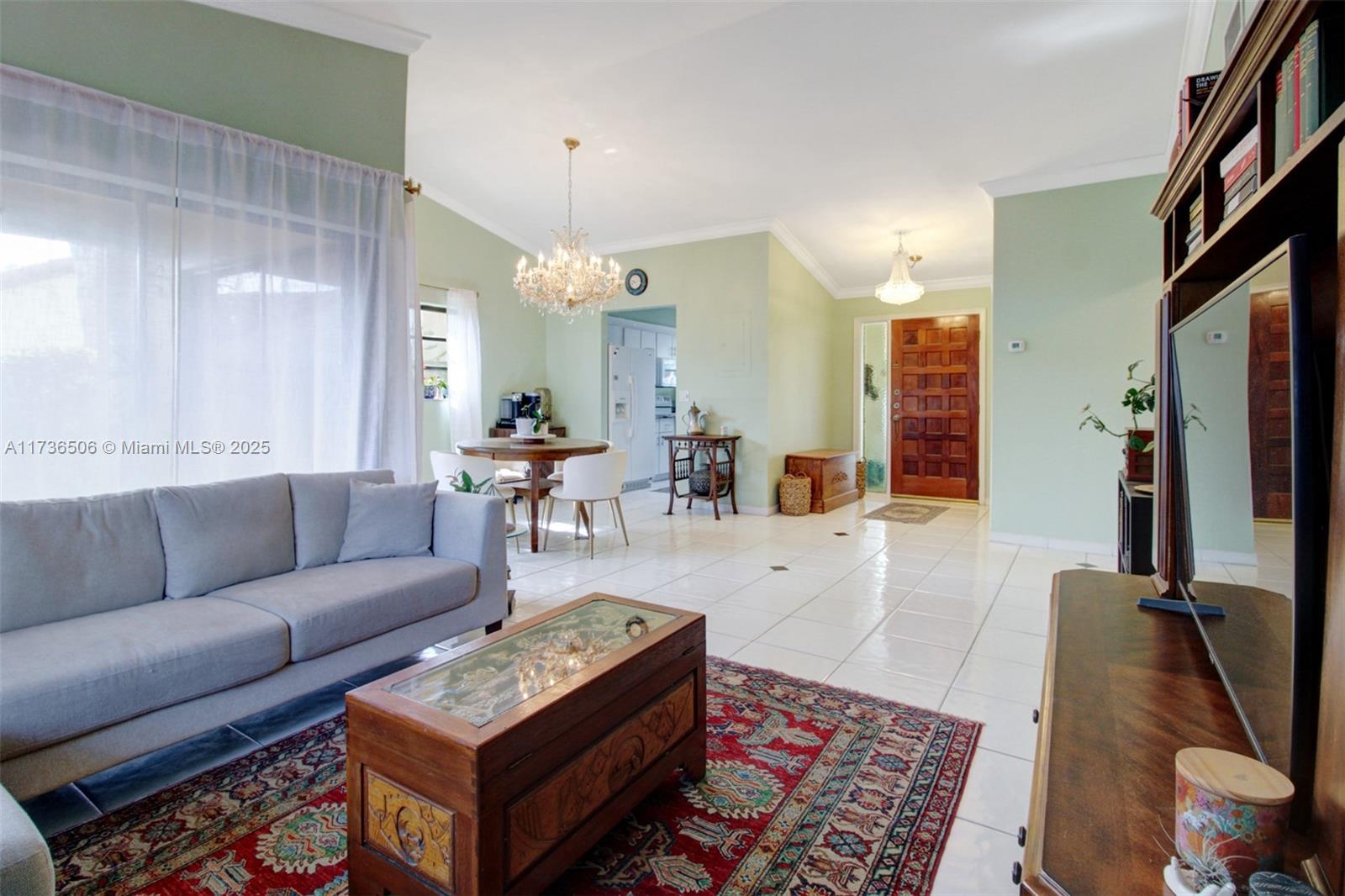 6425 Southwest 133rd Place Miami, FL 33183 - Photo 6 of 25 a living room with furniture and a flat screen tv