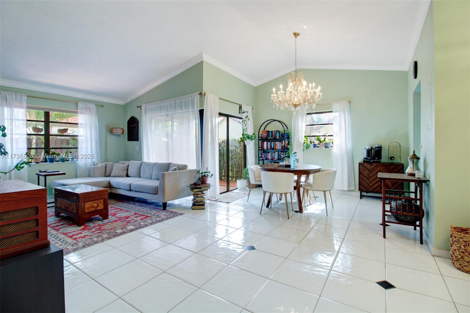 6425 Southwest 133rd Place Miami, FL 33183 - Photo 7 of 25 a living room with furniture a window and a chandelier
