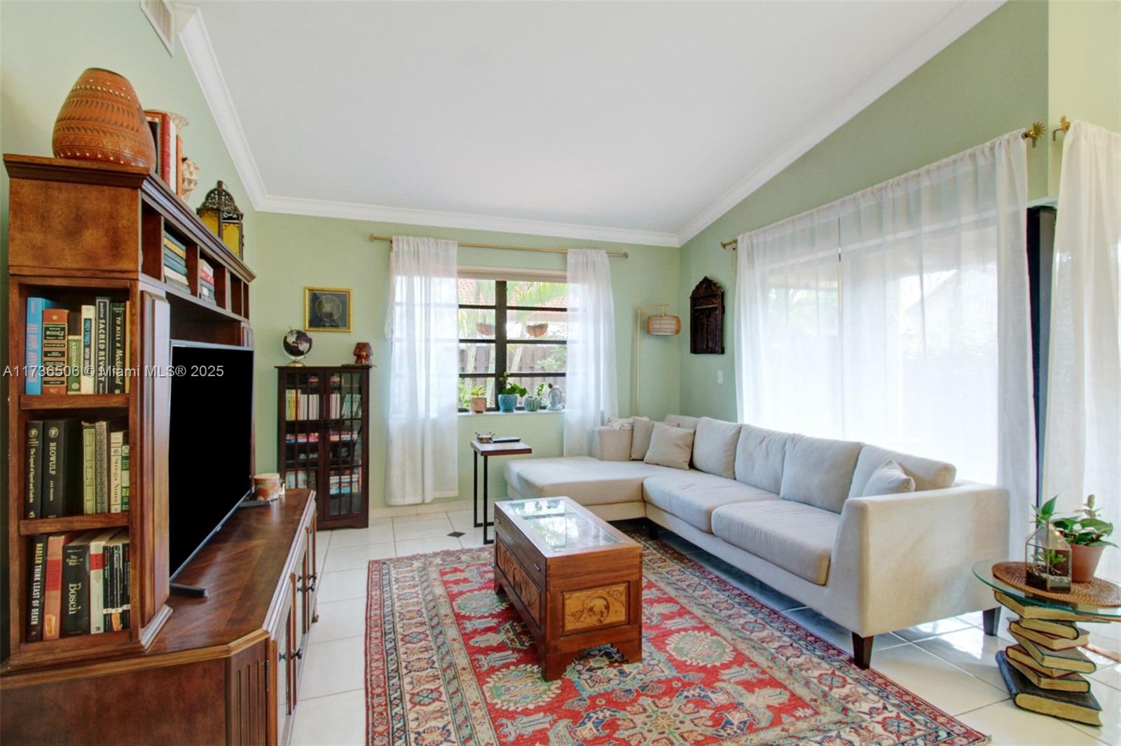 6425 Southwest 133rd Place Miami, FL 33183 - Photo 8 of 25 a living room with furniture a bookshelf and a window