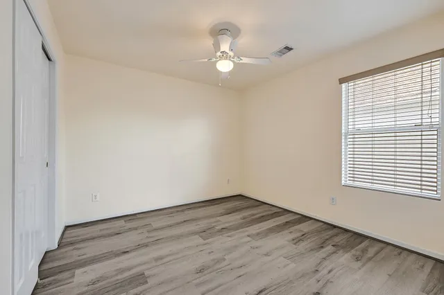 a view of a room with wooden floor and a window