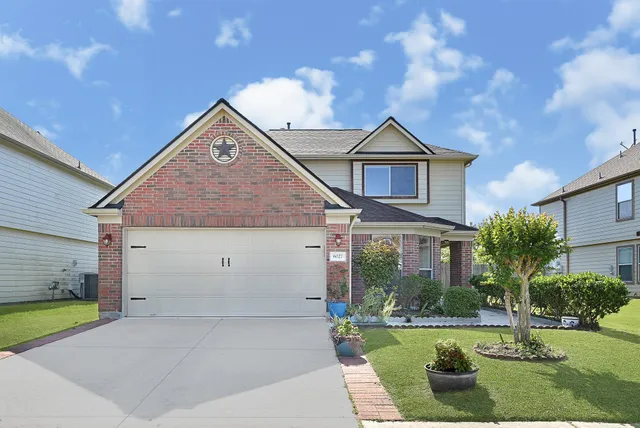a view of a house next to a yard