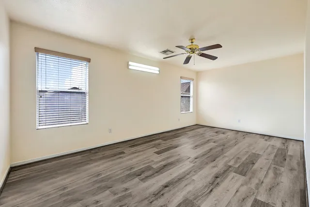 wooden floor in an empty room with a window