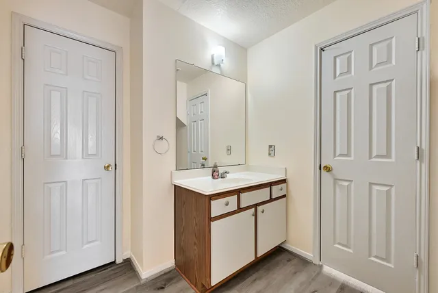 a bathroom with a sink a mirror and a vanity