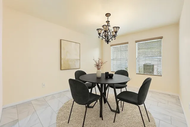 a view of a dining room with furniture and window