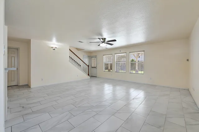 a view of a livingroom with a ceiling fan and window