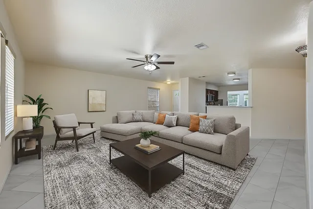 a living room with furniture and a ceiling fan