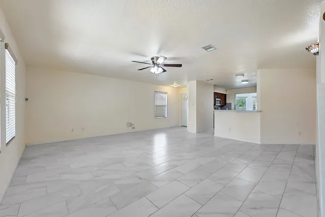 a view of a livingroom with a ceiling fan and window