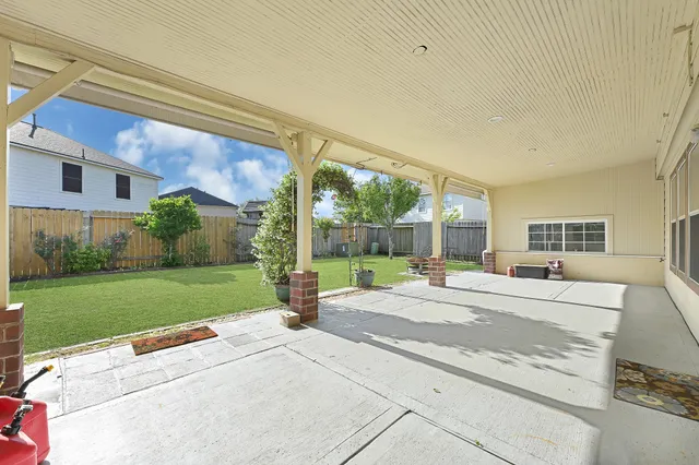 a house view with a backyard space and garden