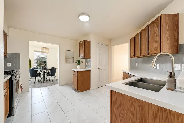 a kitchen with a sink a counter and appliances