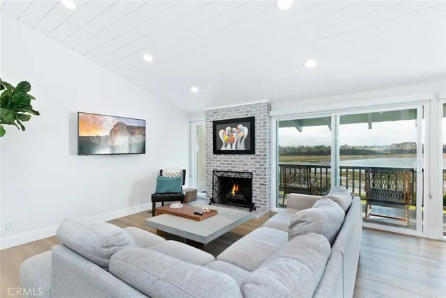 a living room with furniture flat screen tv and a fireplace