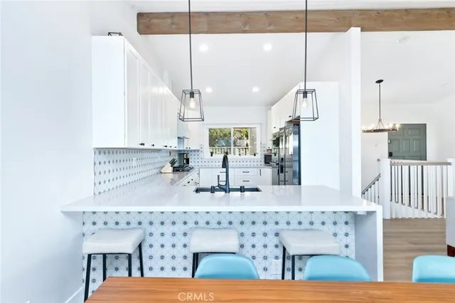 a view of a dining room with furniture a chandelier and wooden floor