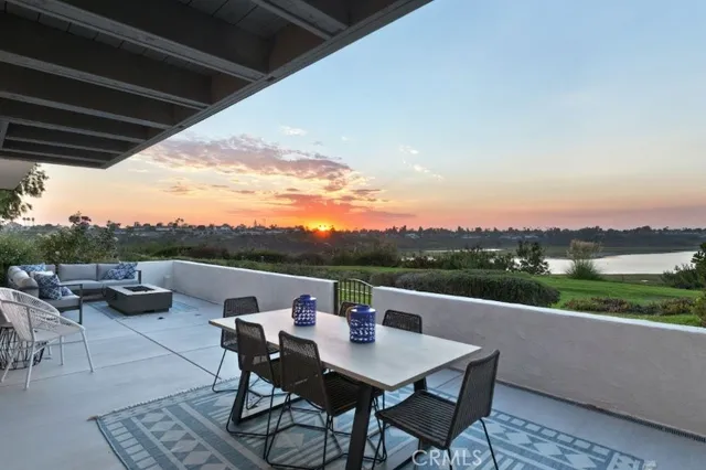 a view of a terrace with furniture and a garden