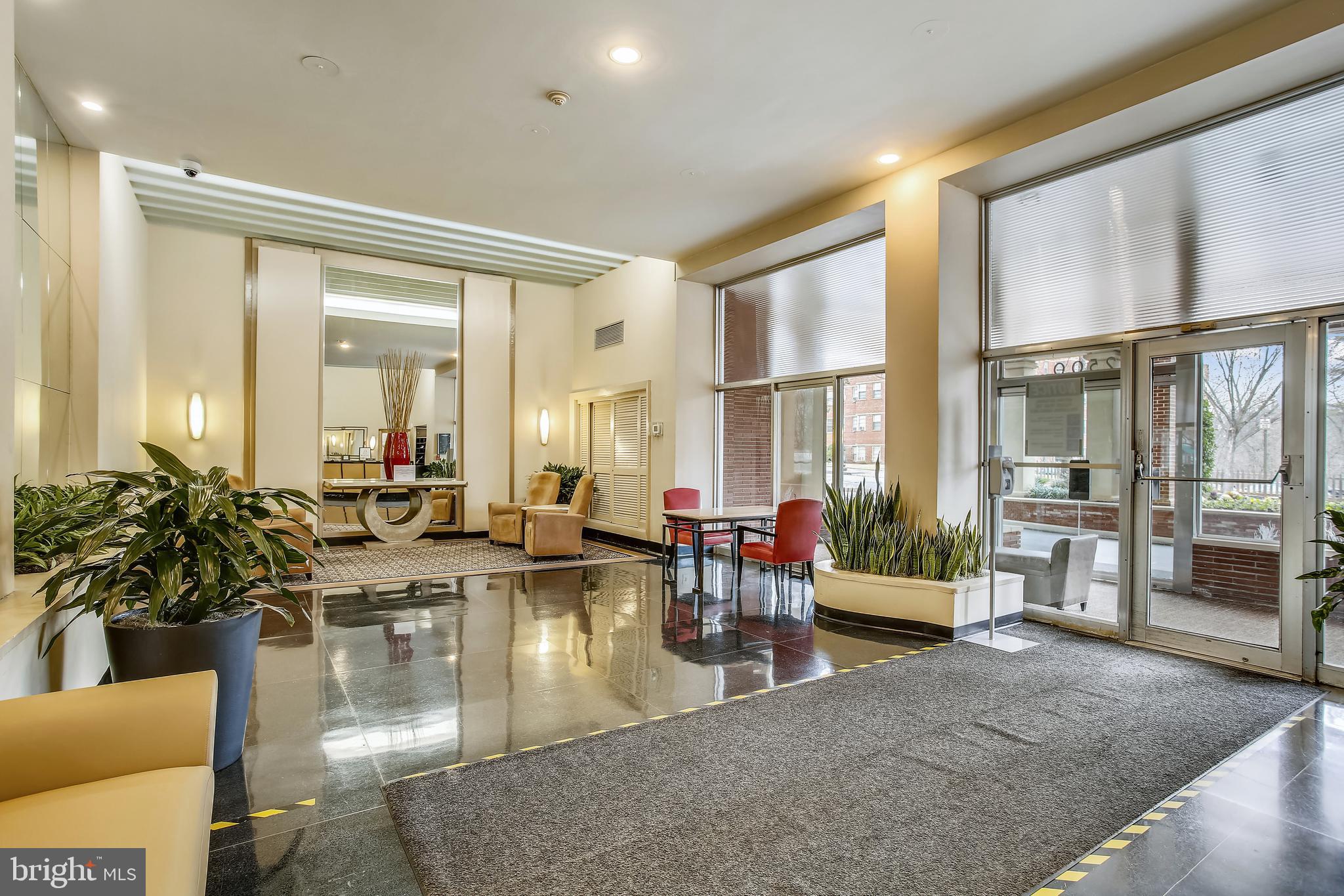 2500 Q Street Northwest, Unit 201 Washington, DC 20007 - Photo 4 of 36 a living room with fireplace furniture and large windows