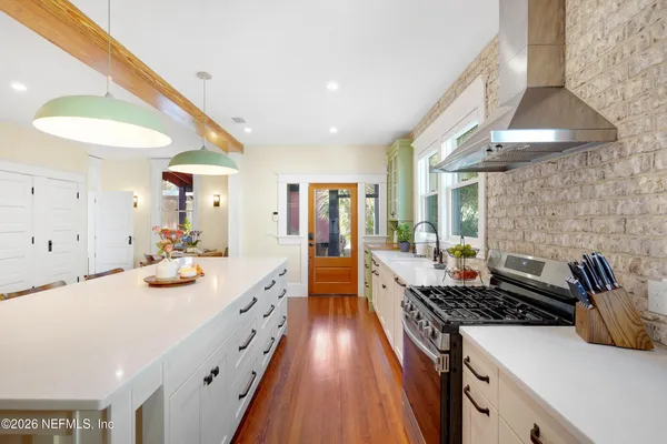 a kitchen with lots of counter top space and dining table