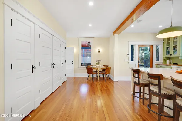 a living room with furniture and floor to ceiling windows