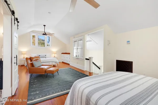 a bedroom with 2 bed and a chandelier