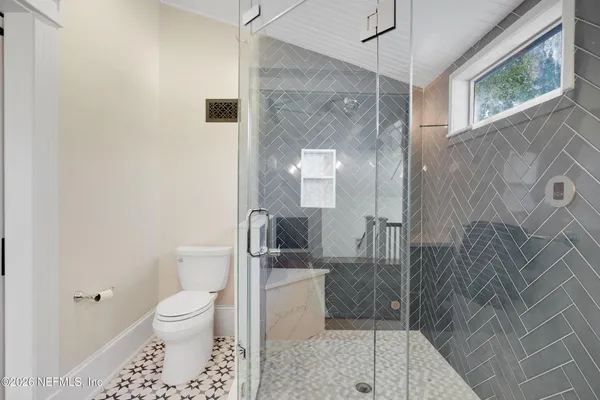 a balcony with furniture and wooden floor