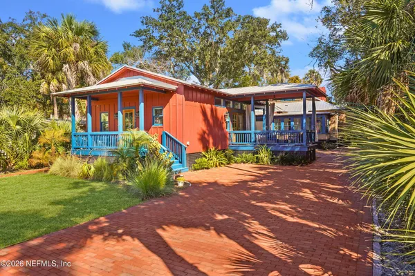 a large kitchen with kitchen island granite countertop a stove a sink dishwasher and a wooden cabinets