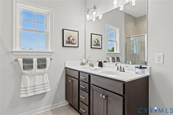 a bathroom with a sink double vanity and a mirror