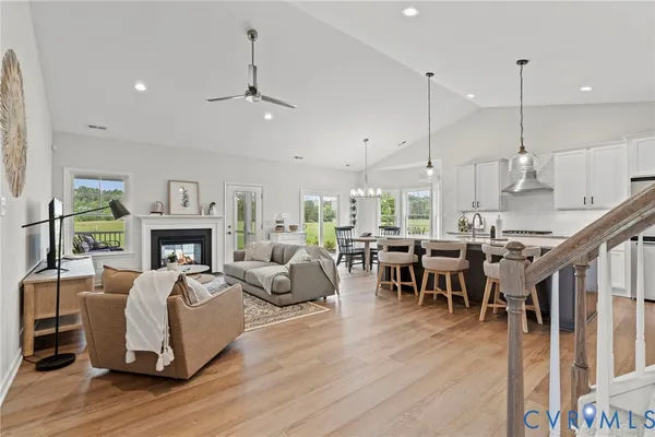 a living room with fireplace furniture and a wooden floor