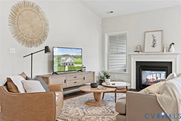 a living room with furniture a table and a fireplace
