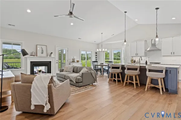 a living room with furniture wooden floor and a fireplace