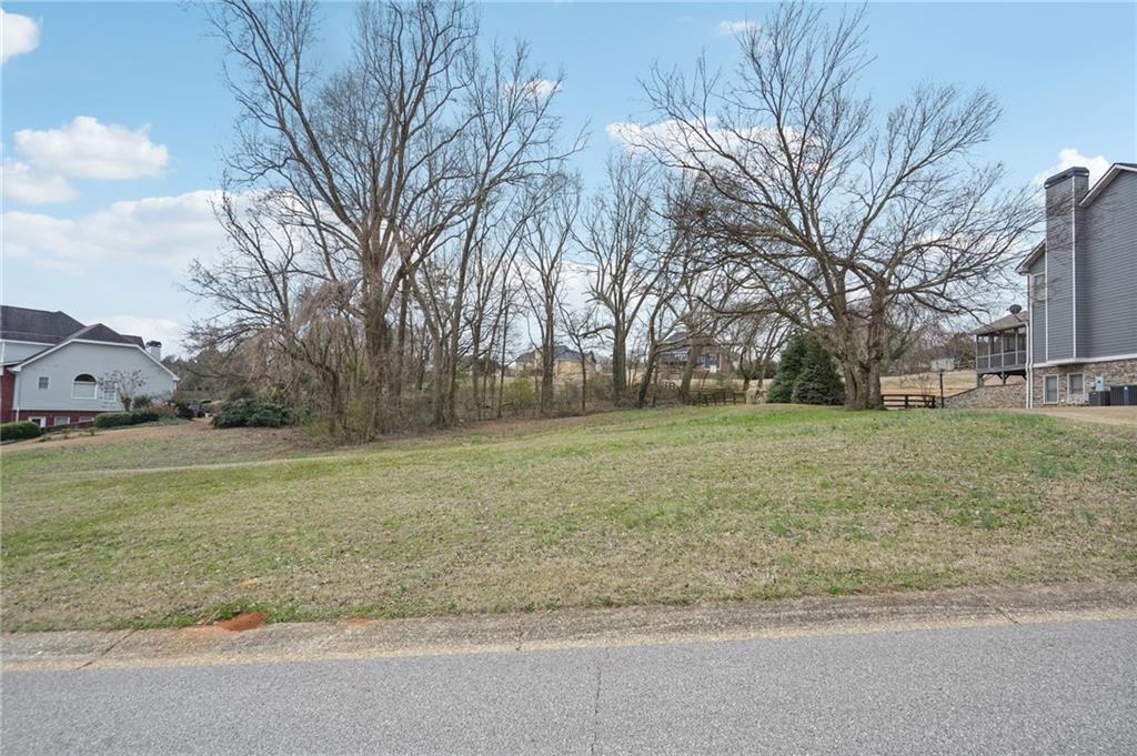 693 Reece Drive Hoschton, GA 30548 - Photo 2 of 16 a view of a field with tree s