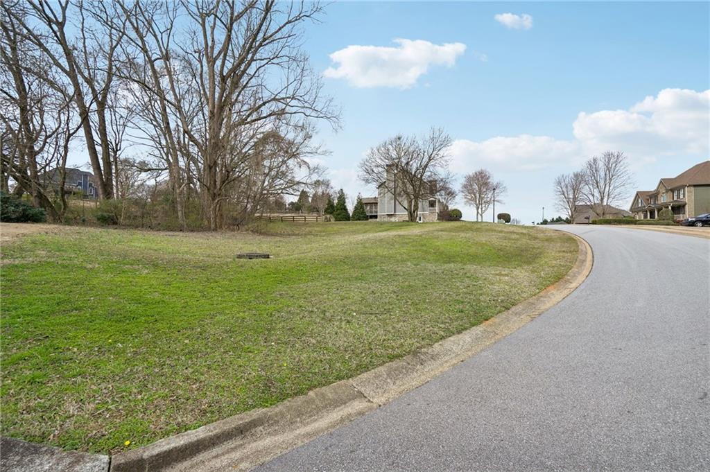 693 Reece Drive Hoschton, GA 30548 - Photo 3 of 16 a view of a golf course with a garden