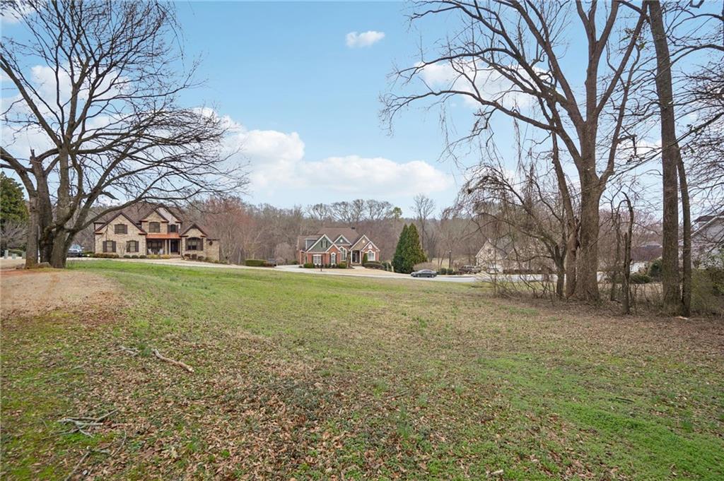 693 Reece Drive Hoschton, GA 30548 - Photo 6 of 16 a view of a field with large trees