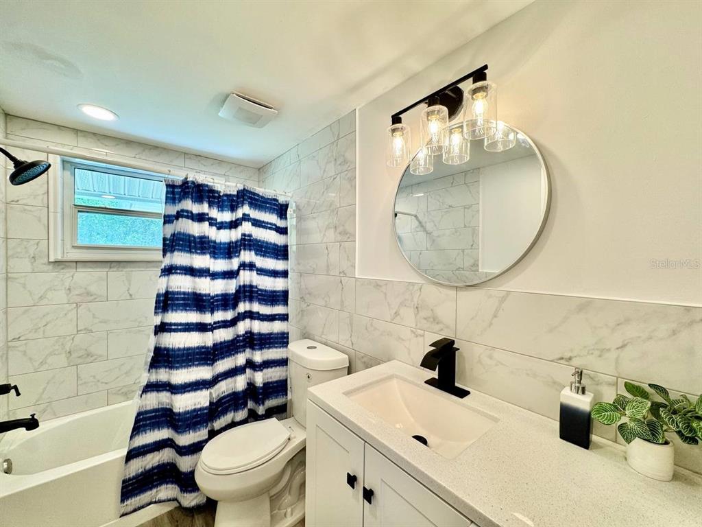 4282 Rudder Way New Port Richey, FL 34652 - Photo 16 of 34 a bathroom with a sink a toilet and a mirror