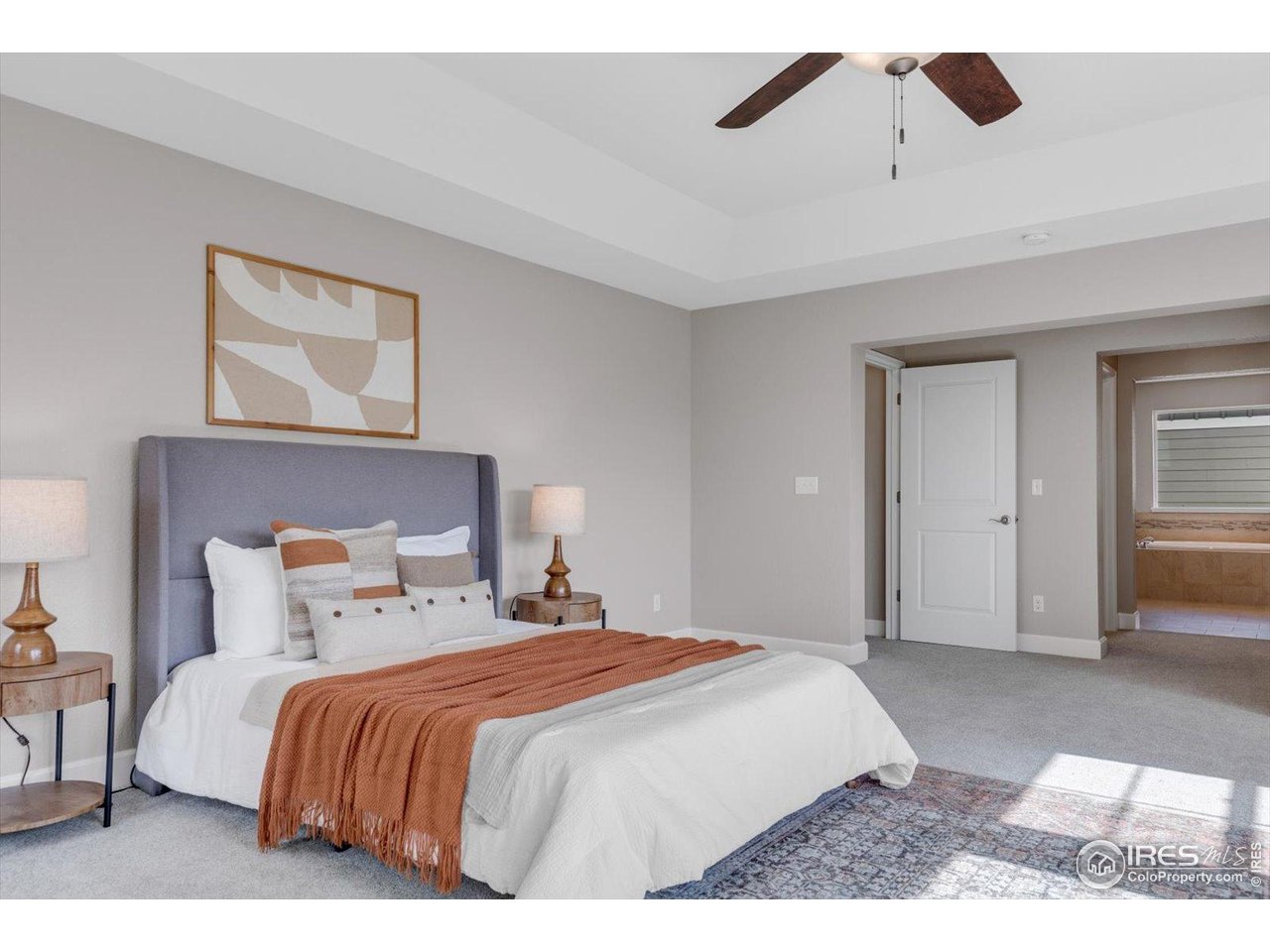 2264 Front Range Road Erie, CO 80516 - Photo 21 of 40 Primary Bedroom Tray Ceiling w/peek into En Suite Bath