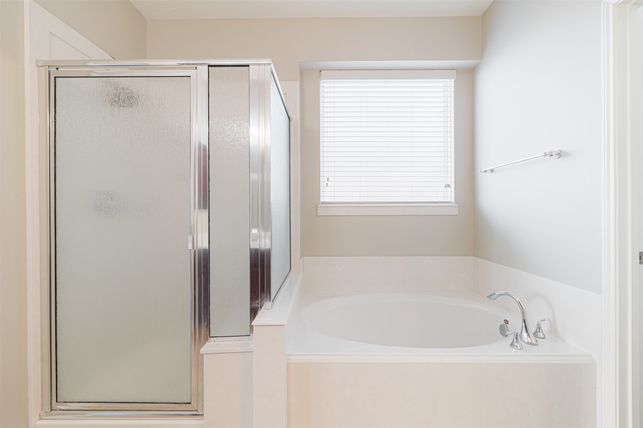 8322 Encinitas Cove Drive Tomball, TX 77375 - Photo 12 of 24 a white bath tub sitting next to a window