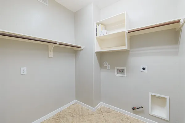 a view of walk in closet with empty racks