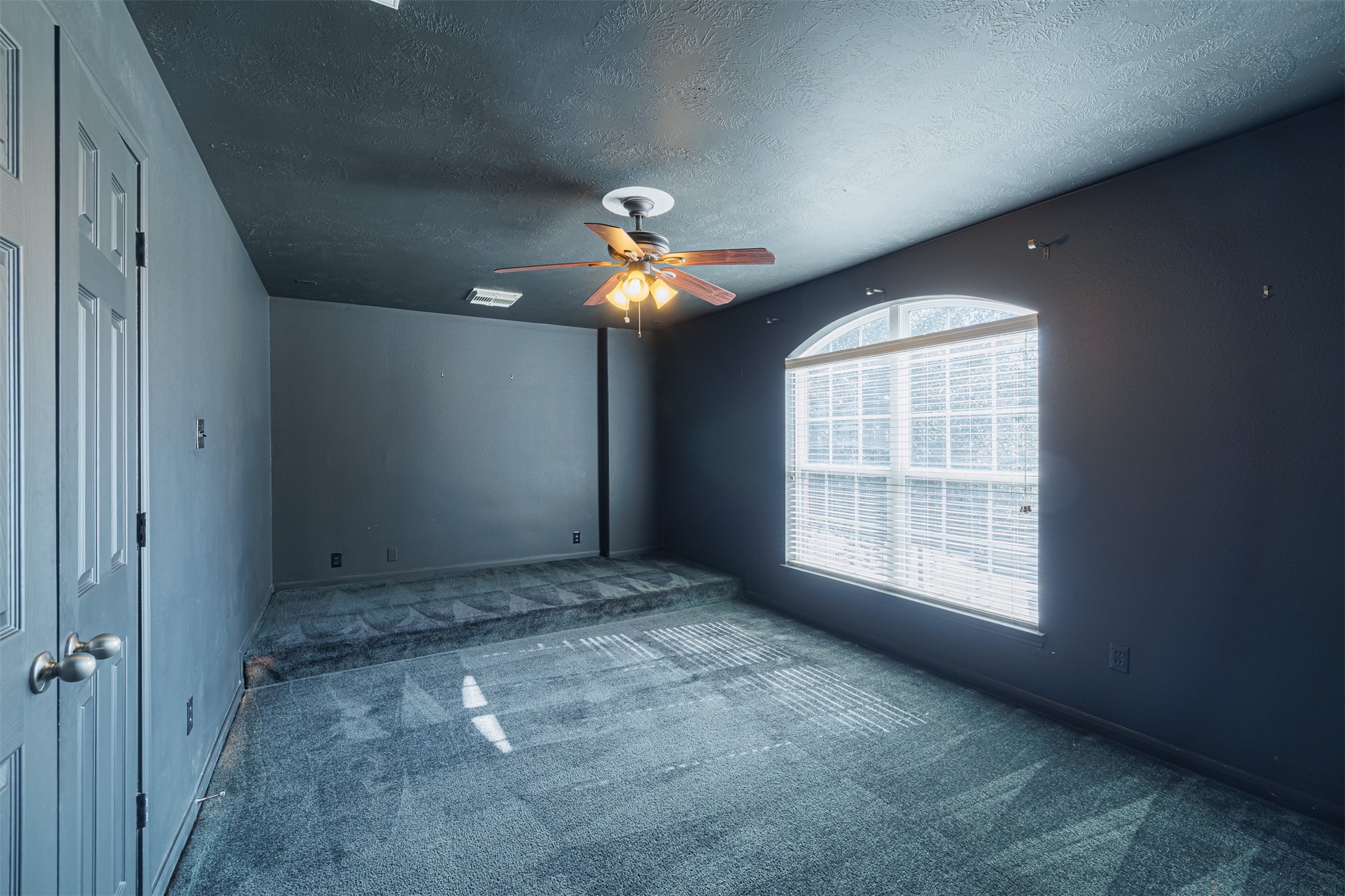 8322 Encinitas Cove Drive Tomball, TX 77375 - Photo 19 of 24 an empty room with chandelier fan and windows