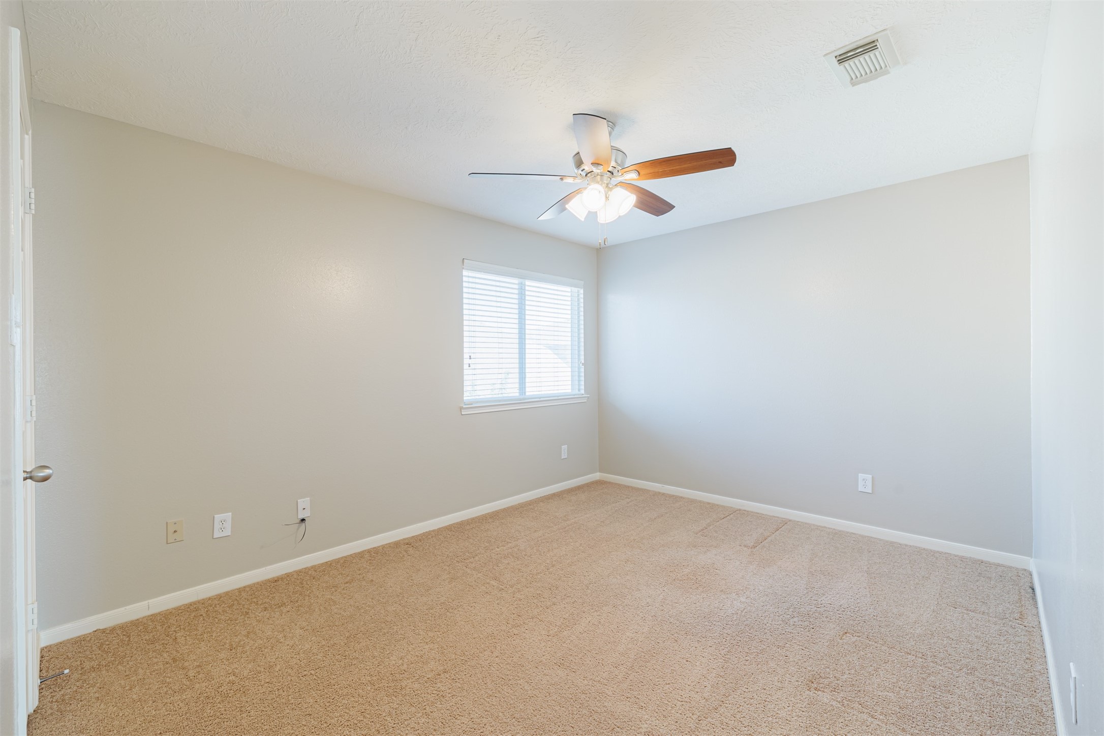 8322 Encinitas Cove Drive Tomball, TX 77375 - Photo 22 of 24 an empty room with a window and a fan