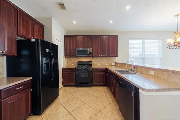 a kitchen with a refrigerator stove and sink