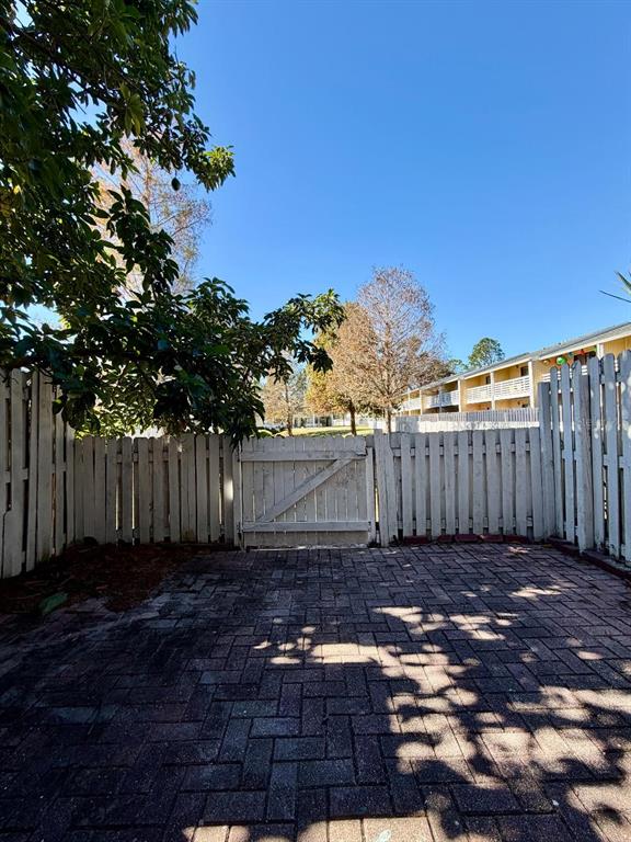 22726 Gage Loop, Unit 43 Land O' Lakes, FL 34639 - Photo 20 of 24 a view of a yard with wooden fence