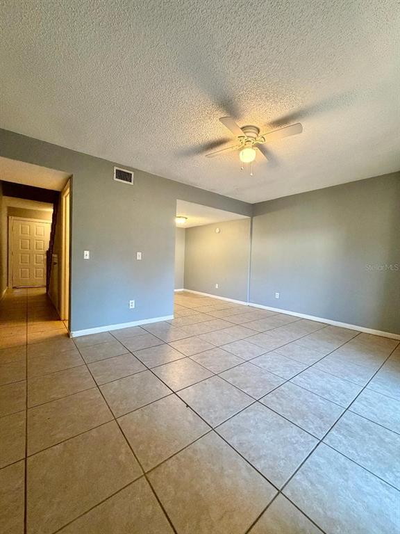 22726 Gage Loop, Unit 43 Land O' Lakes, FL 34639 - Photo 6 of 24 a view of a livingroom with a ceiling fan and window